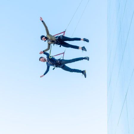 a man and woman jumping from a building